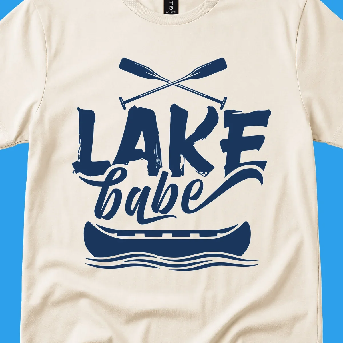 Lake babe text with canoe and oars on water. Primary keyword: lake-babe-canoe