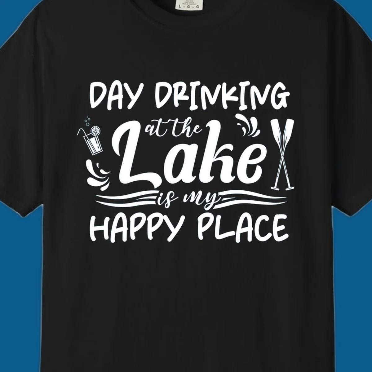 Typography design 'Day Drinking at the Lake is My Happy Place' with lake-themed illustrations.