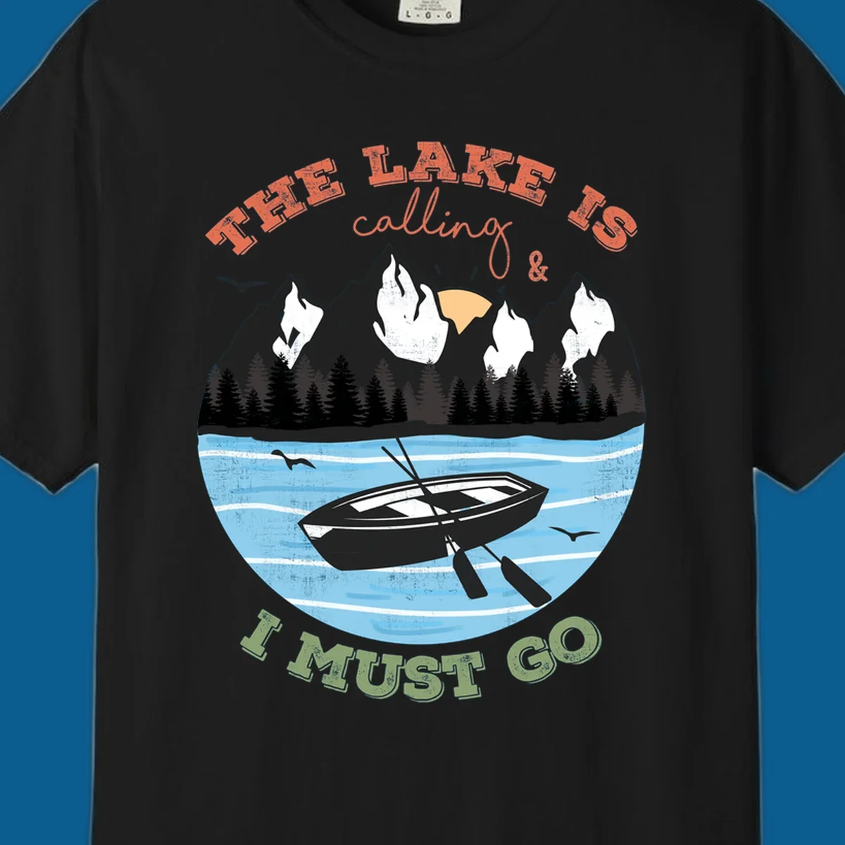 The lake is calling and I must go mountain lake scene with rowboat graphic