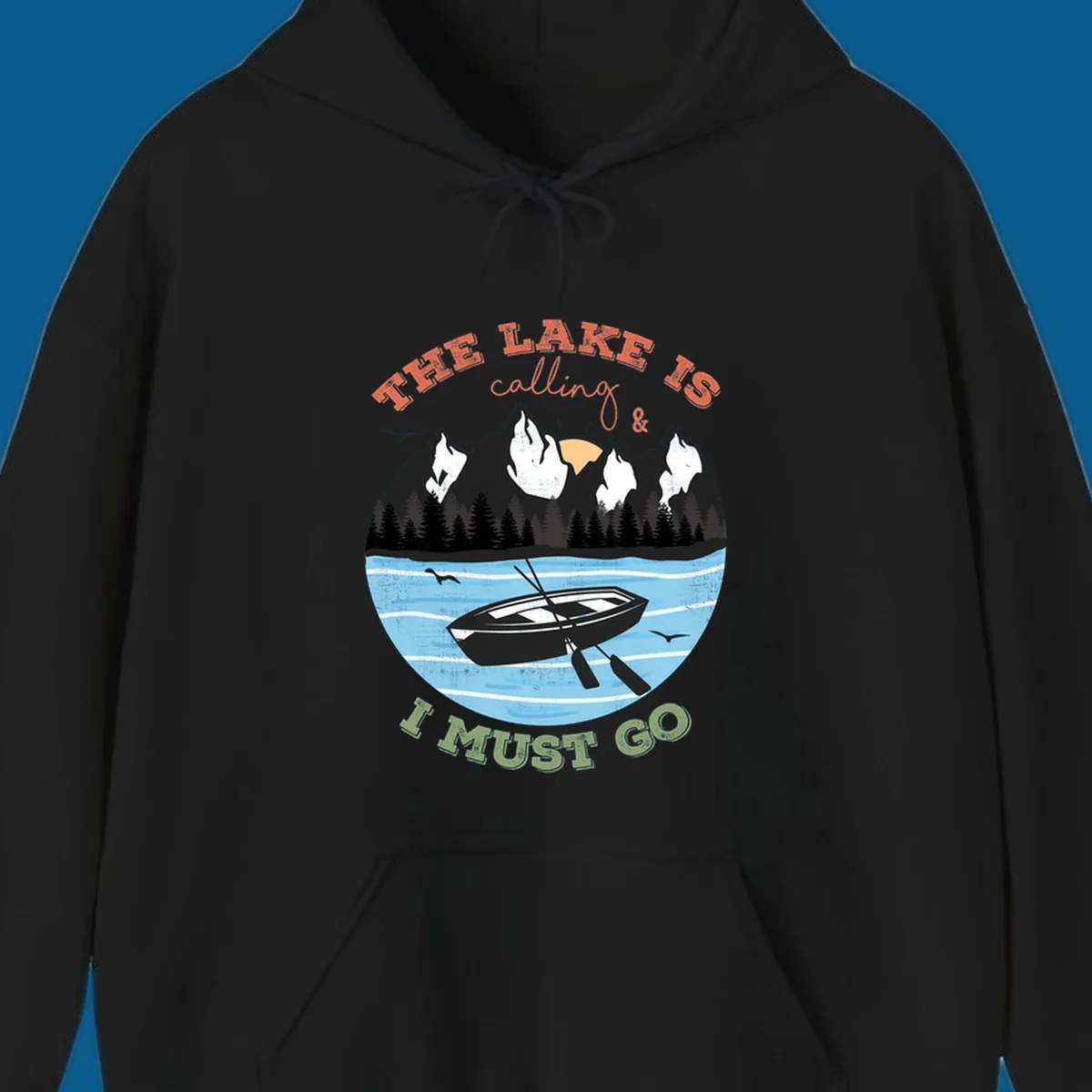 The lake is calling and I must go mountain lake scene with rowboat graphic