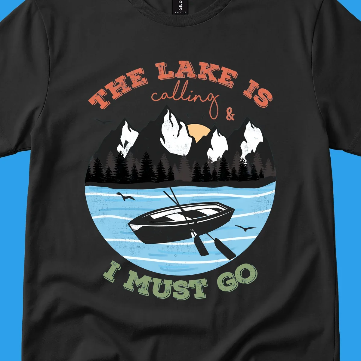 The lake is calling and I must go mountain lake scene with rowboat graphic