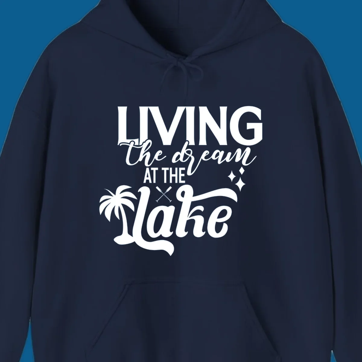 Living the dream at the lake text with palm tree and oars graphic