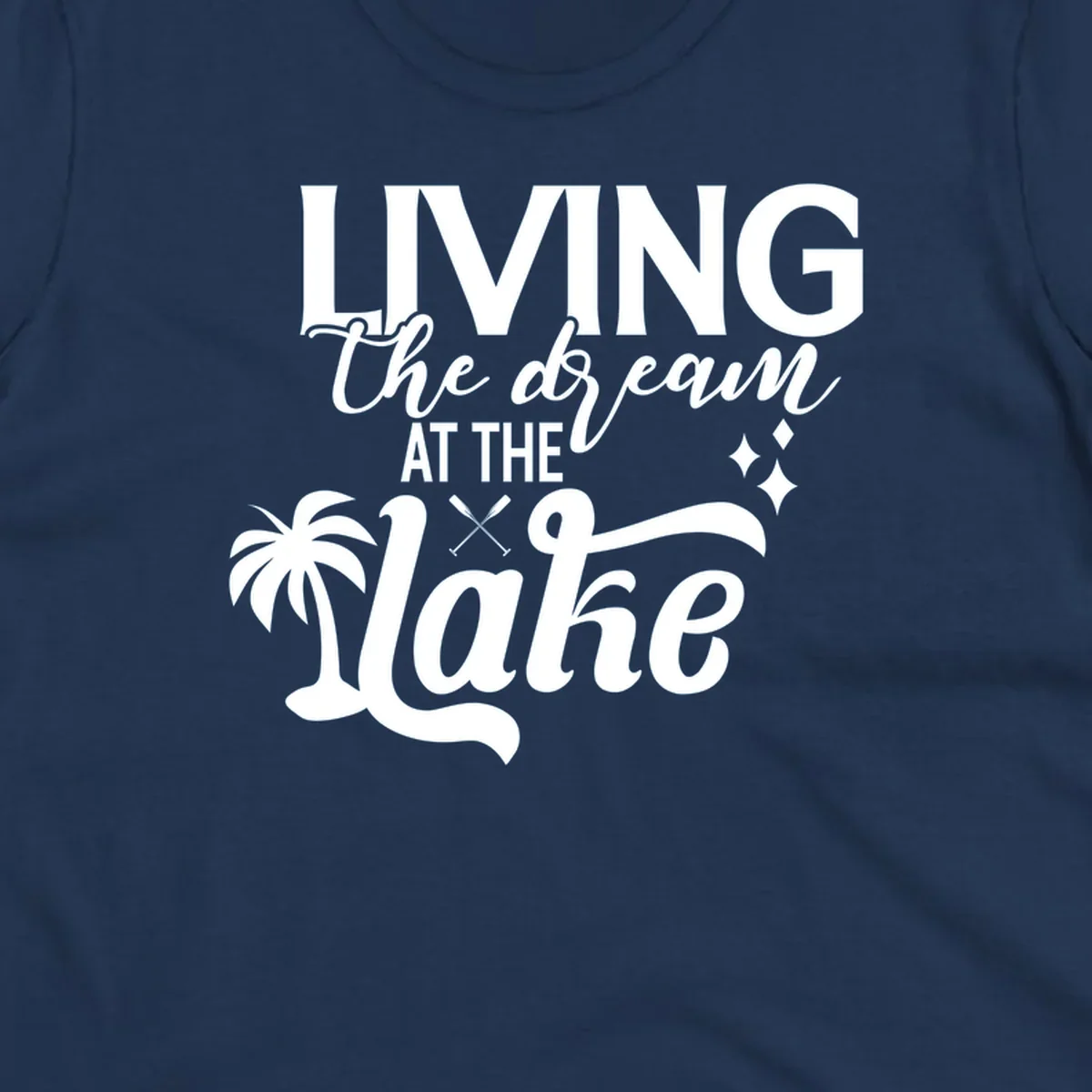 Living the dream at the lake text with palm tree and oars graphic