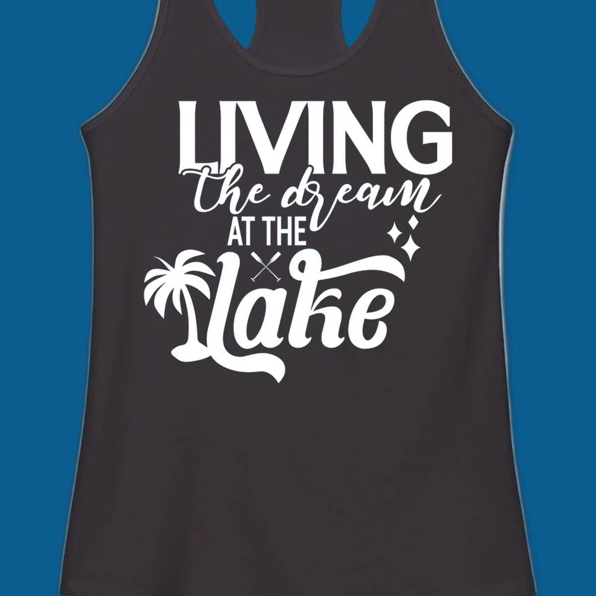 Living the dream at the lake text with palm tree and oars graphic