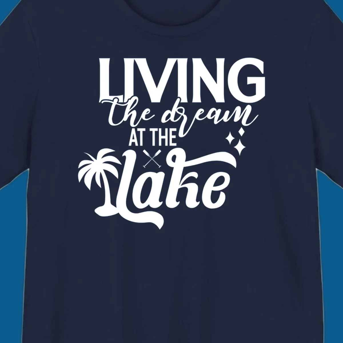 Living the dream at the lake text with palm tree and oars graphic
