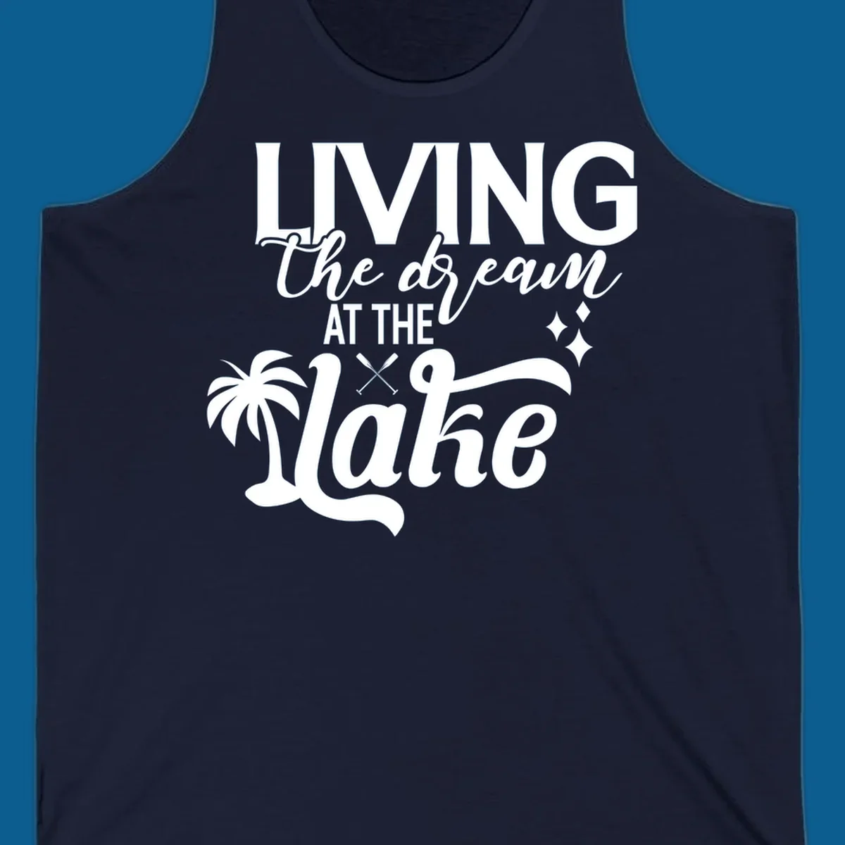 Living the dream at the lake text with palm tree and oars graphic