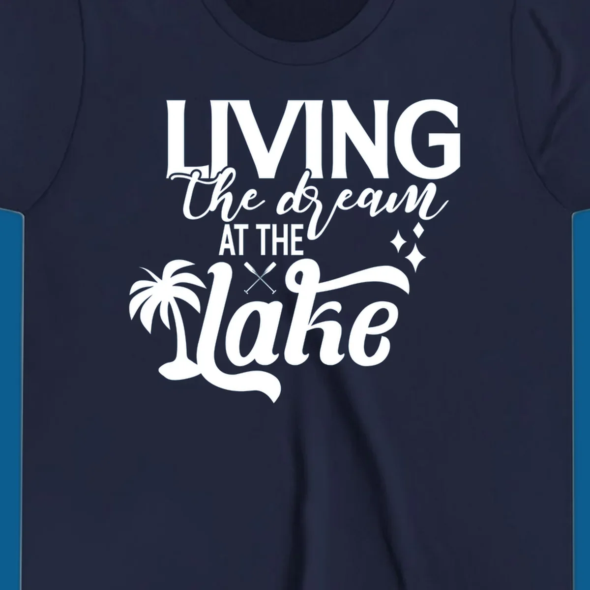 Living the dream at the lake text with palm tree and oars graphic