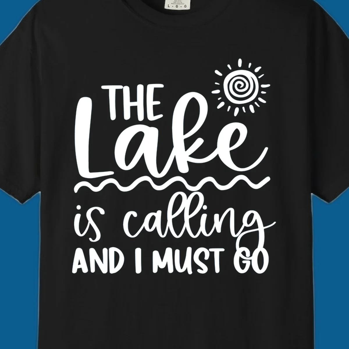 The lake is calling and I must go typography with sun and waves graphic