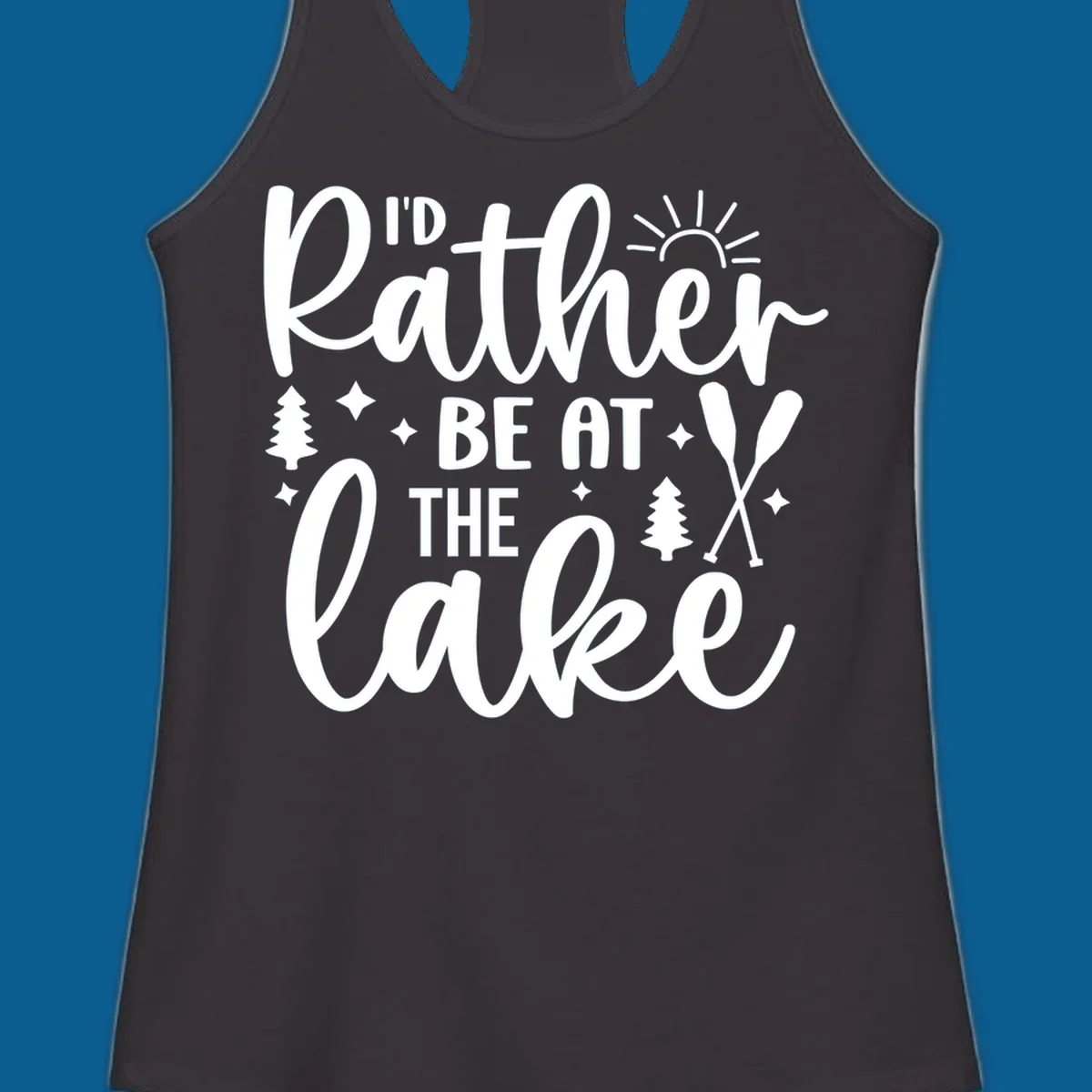 I'd Rather Be At The Lake typography design with sun rays, trees, and oars.