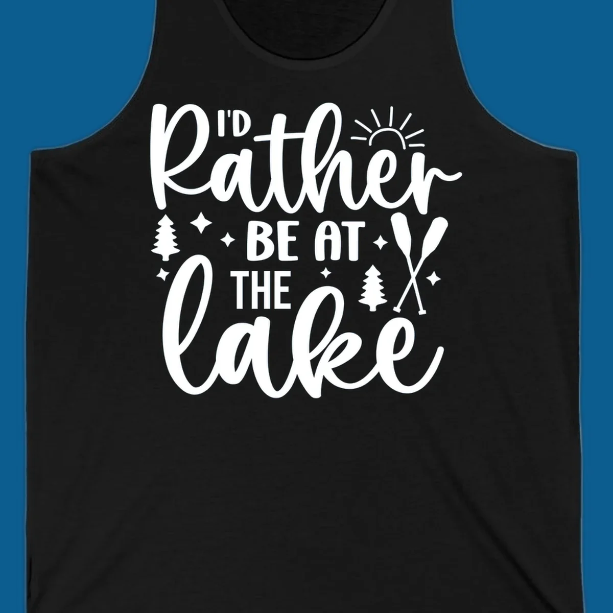 I'd Rather Be At The Lake typography design with sun rays, trees, and oars.