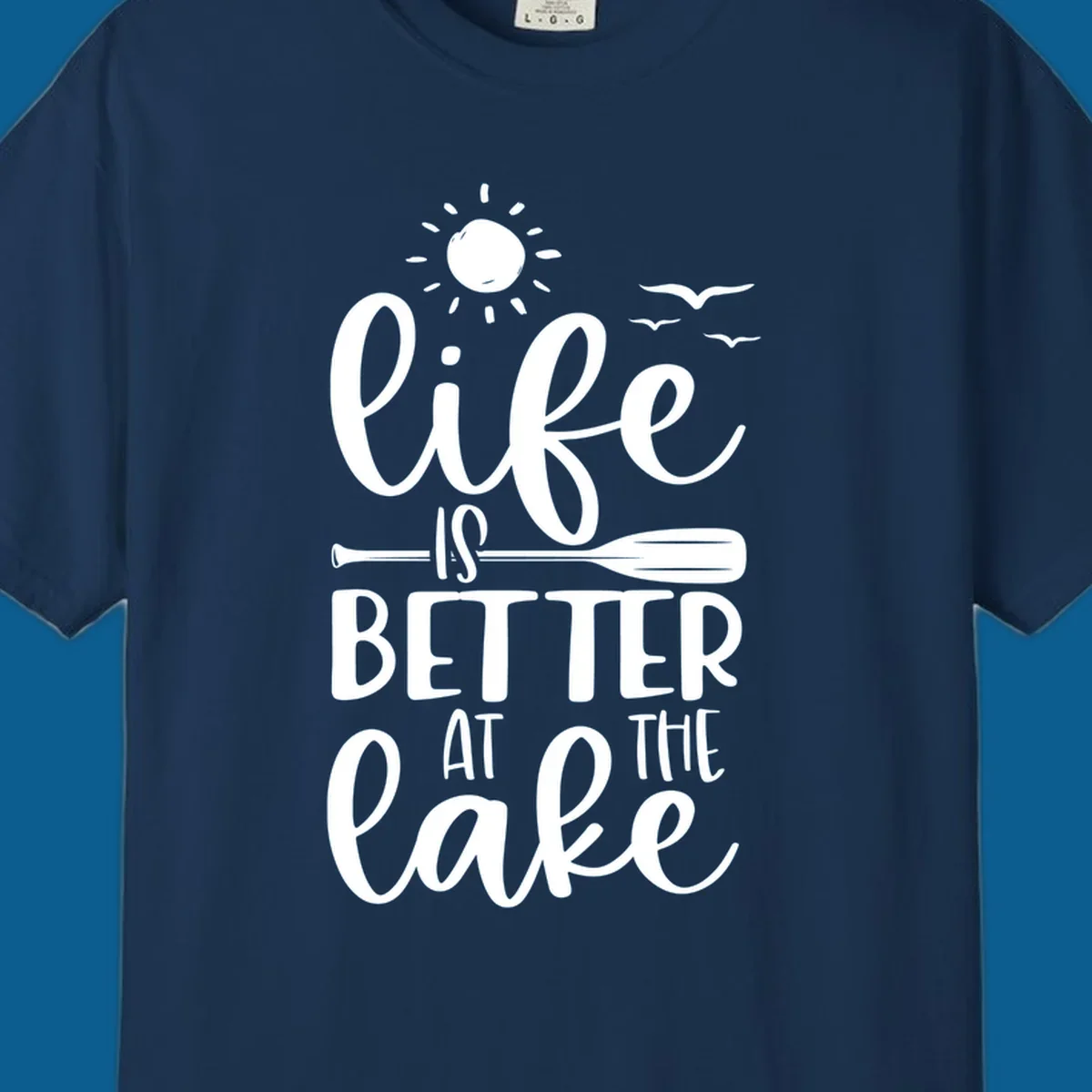 Life is better at the lake quote with sun, birds, and oar graphic.