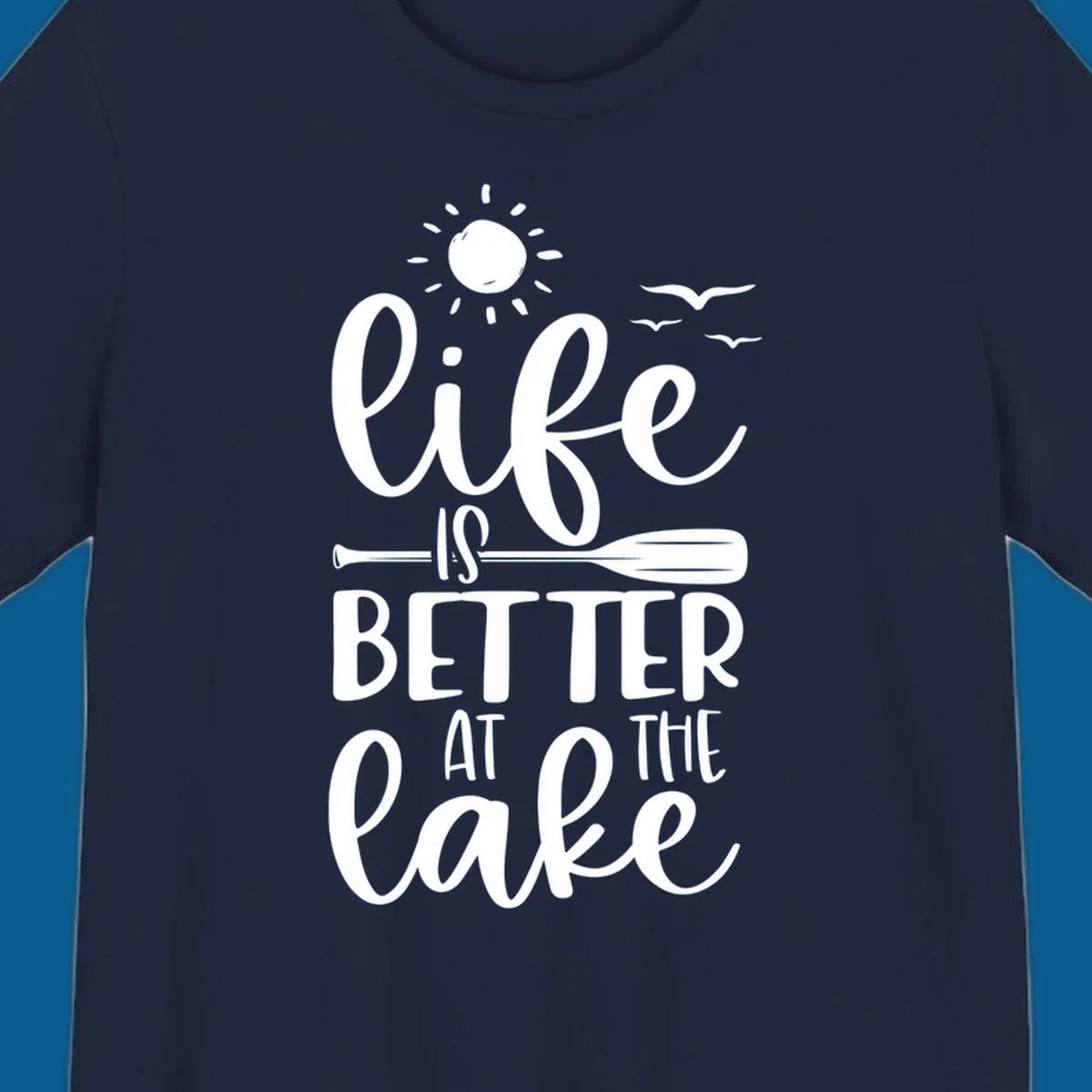 Life is better at the lake quote with sun, birds, and oar graphic.