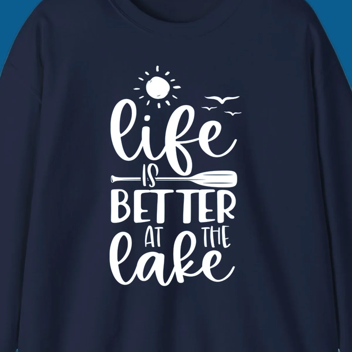 Life is better at the lake quote with sun, birds, and oar graphic.