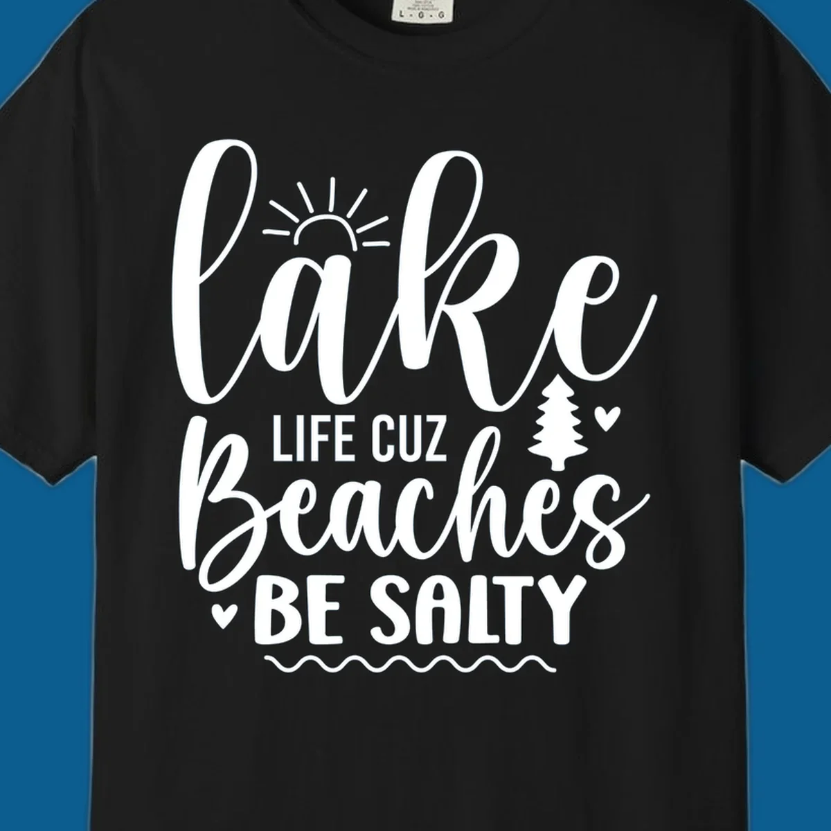 Lake life cuz beaches be salty text design with sun and tree elements.