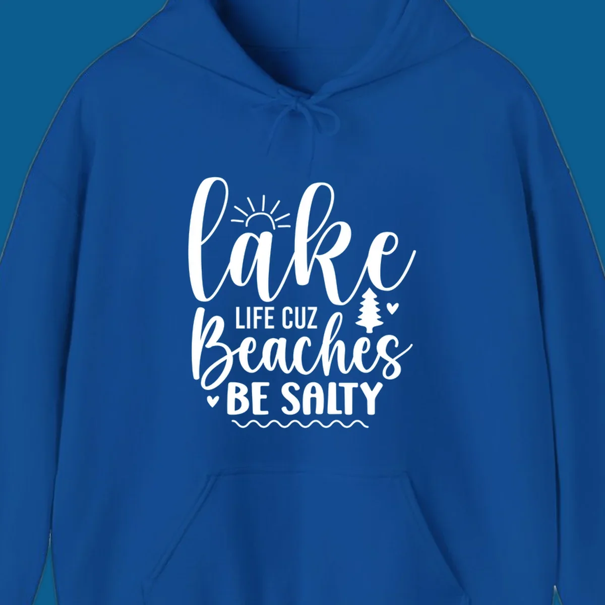 Lake life cuz beaches be salty text design with sun and tree elements.