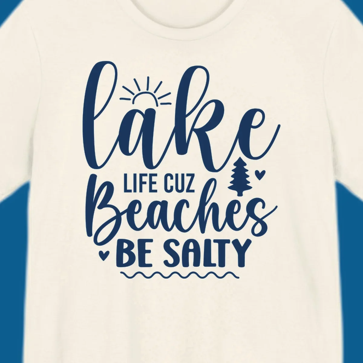 Lake life cuz beaches be salty text design with sun and tree elements.