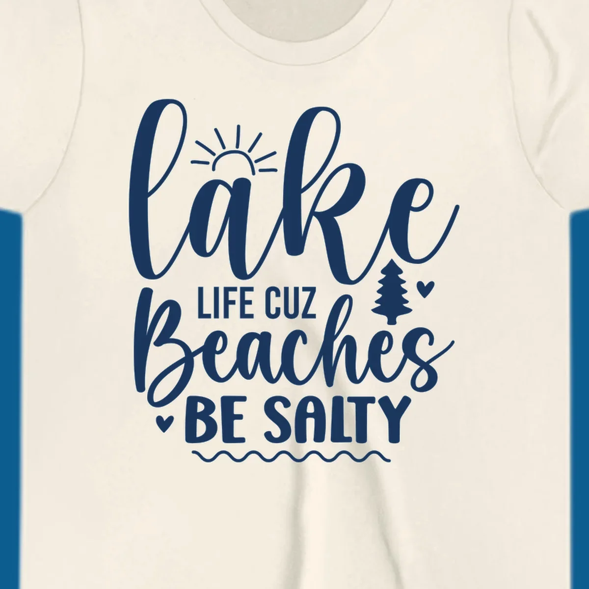 Lake life cuz beaches be salty text design with sun and tree elements.