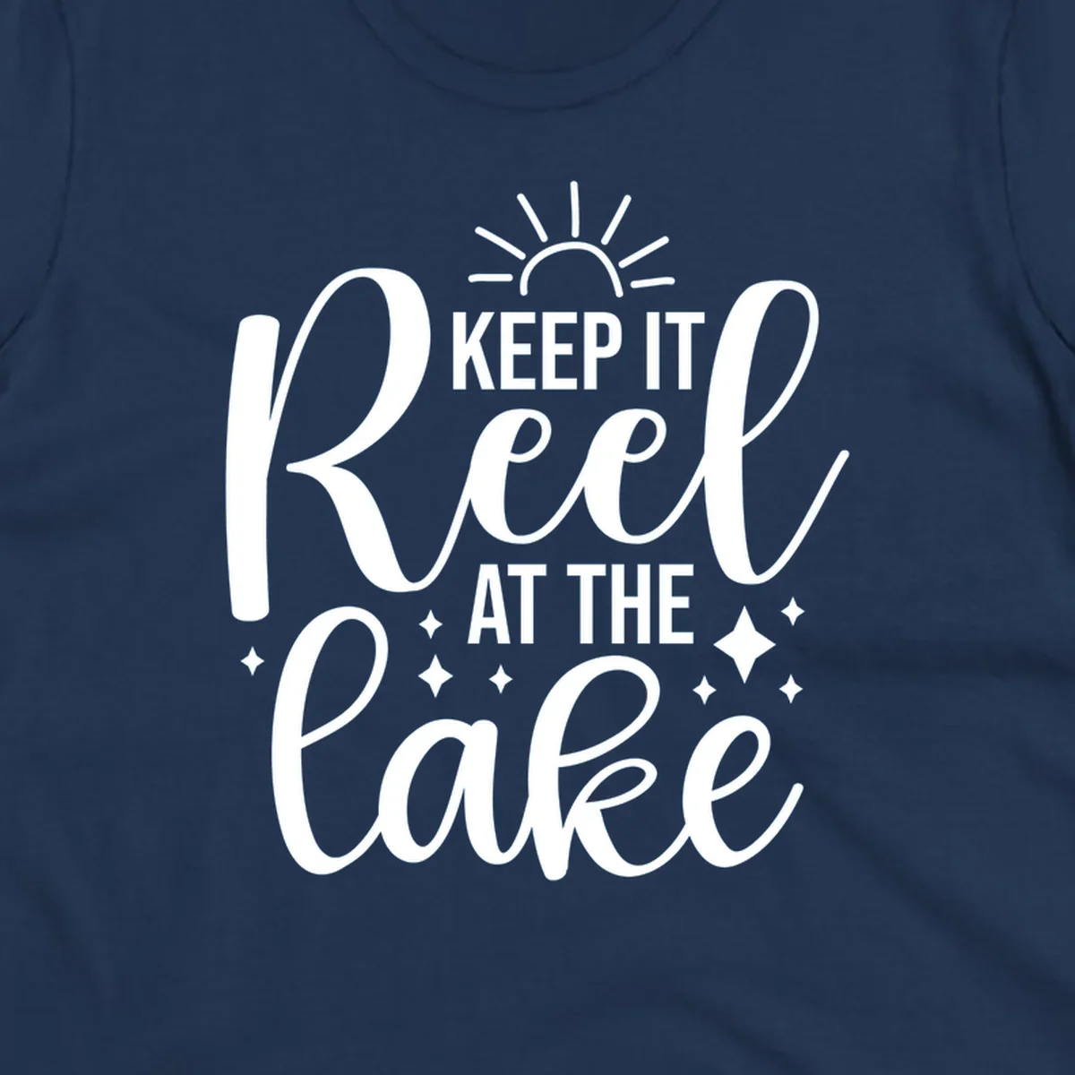 Keep It Reel At The Lake design with sun rays and sparkles, a lakeside lifestyle graphic.