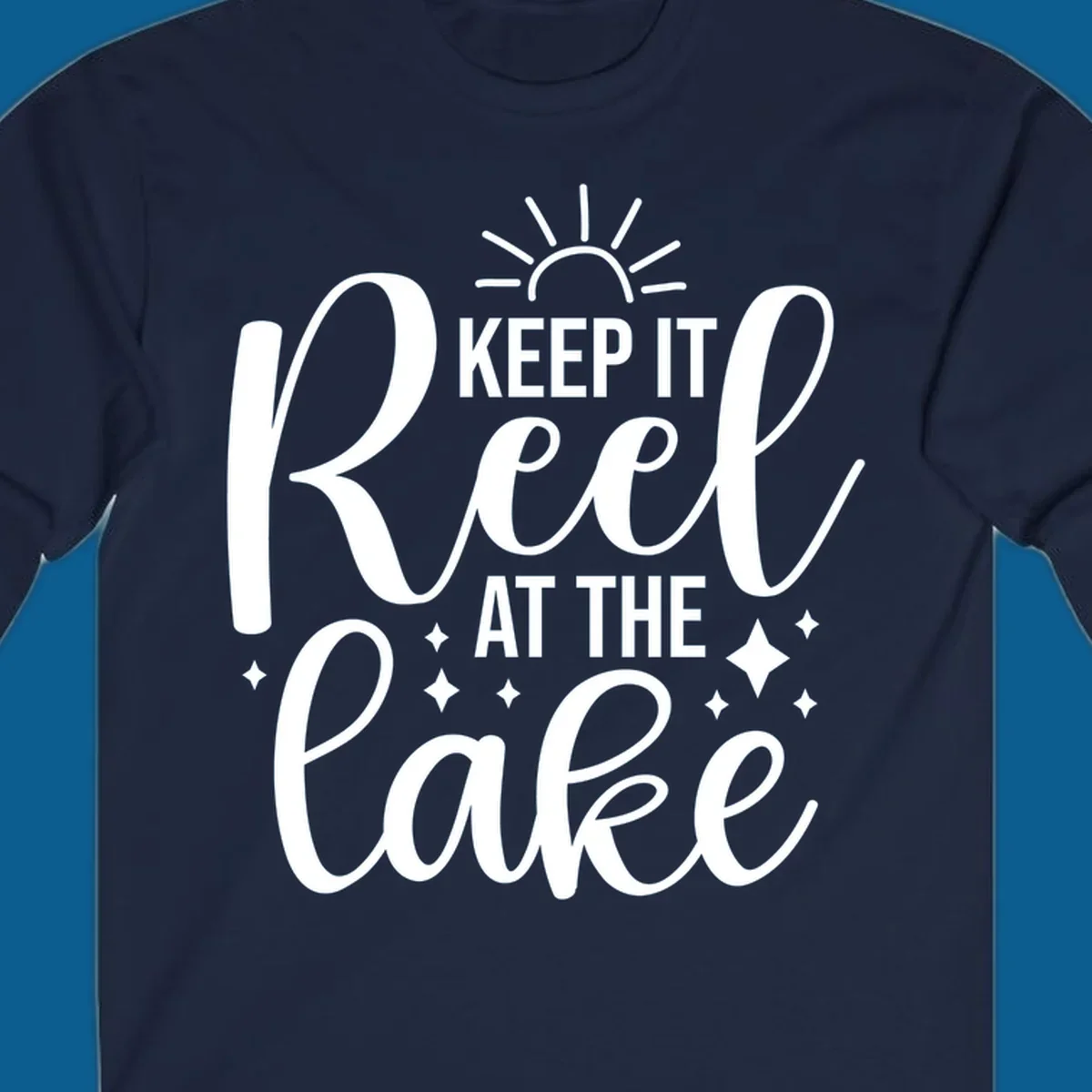 Keep It Reel At The Lake design with sun rays and sparkles, a lakeside lifestyle graphic.