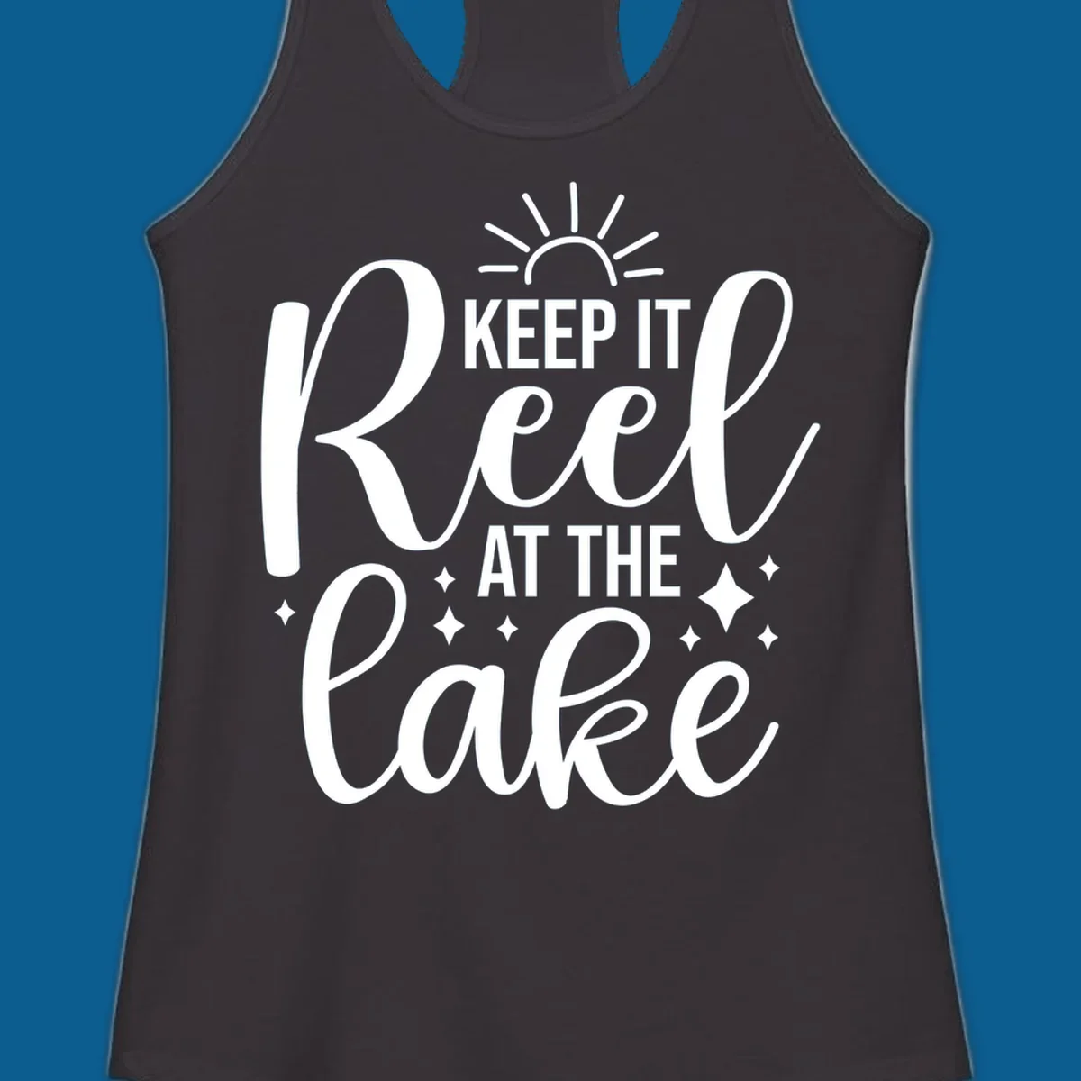 Keep It Reel At The Lake design with sun rays and sparkles, a lakeside lifestyle graphic.