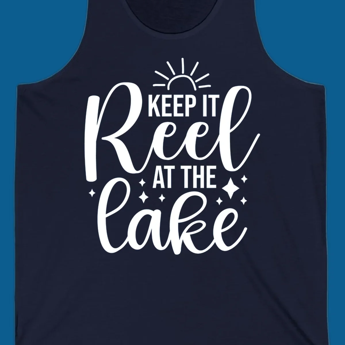 Keep It Reel At The Lake design with sun rays and sparkles, a lakeside lifestyle graphic.