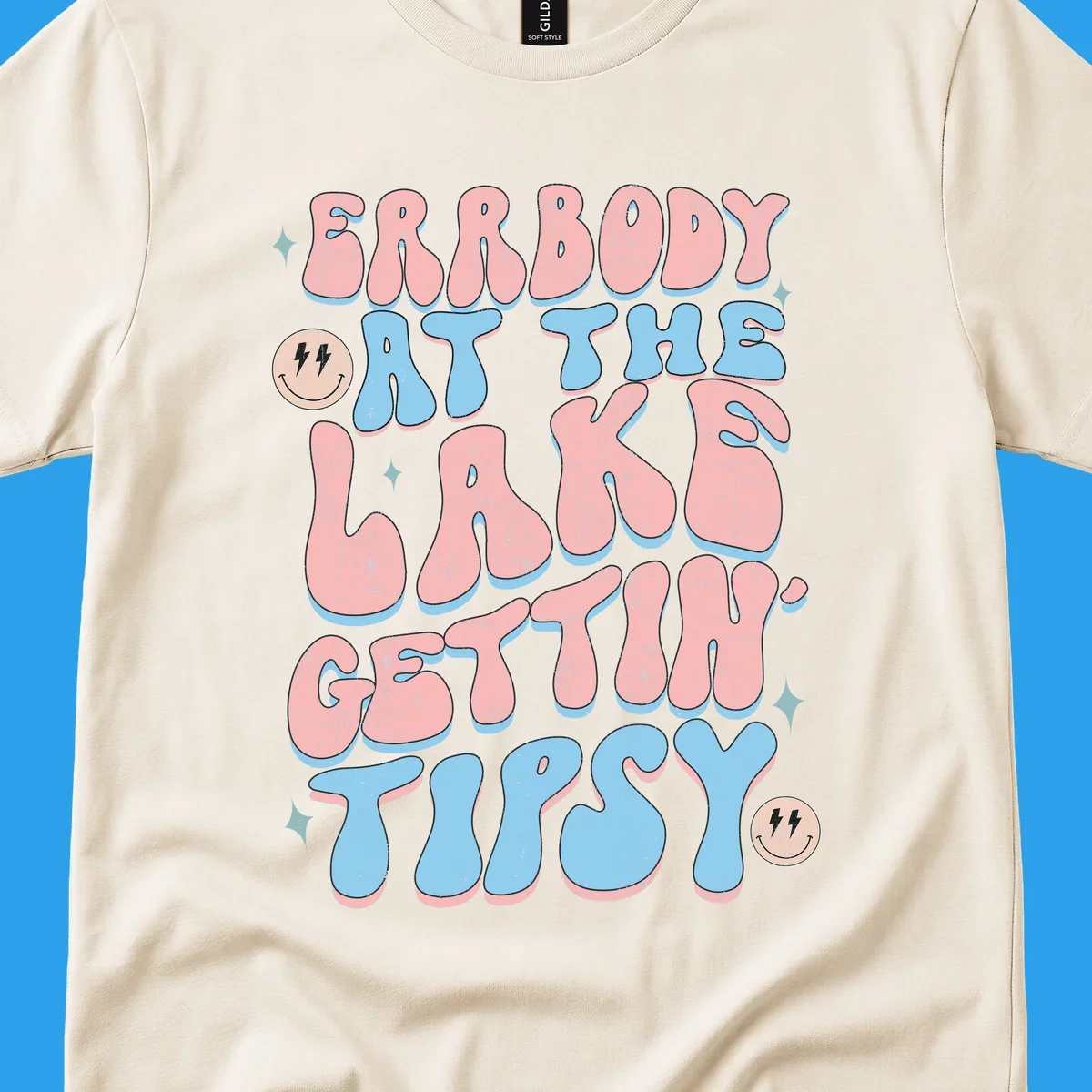 Everybody Gettin Tipsy At The Lake retro text design with smiley faces and sparkles.