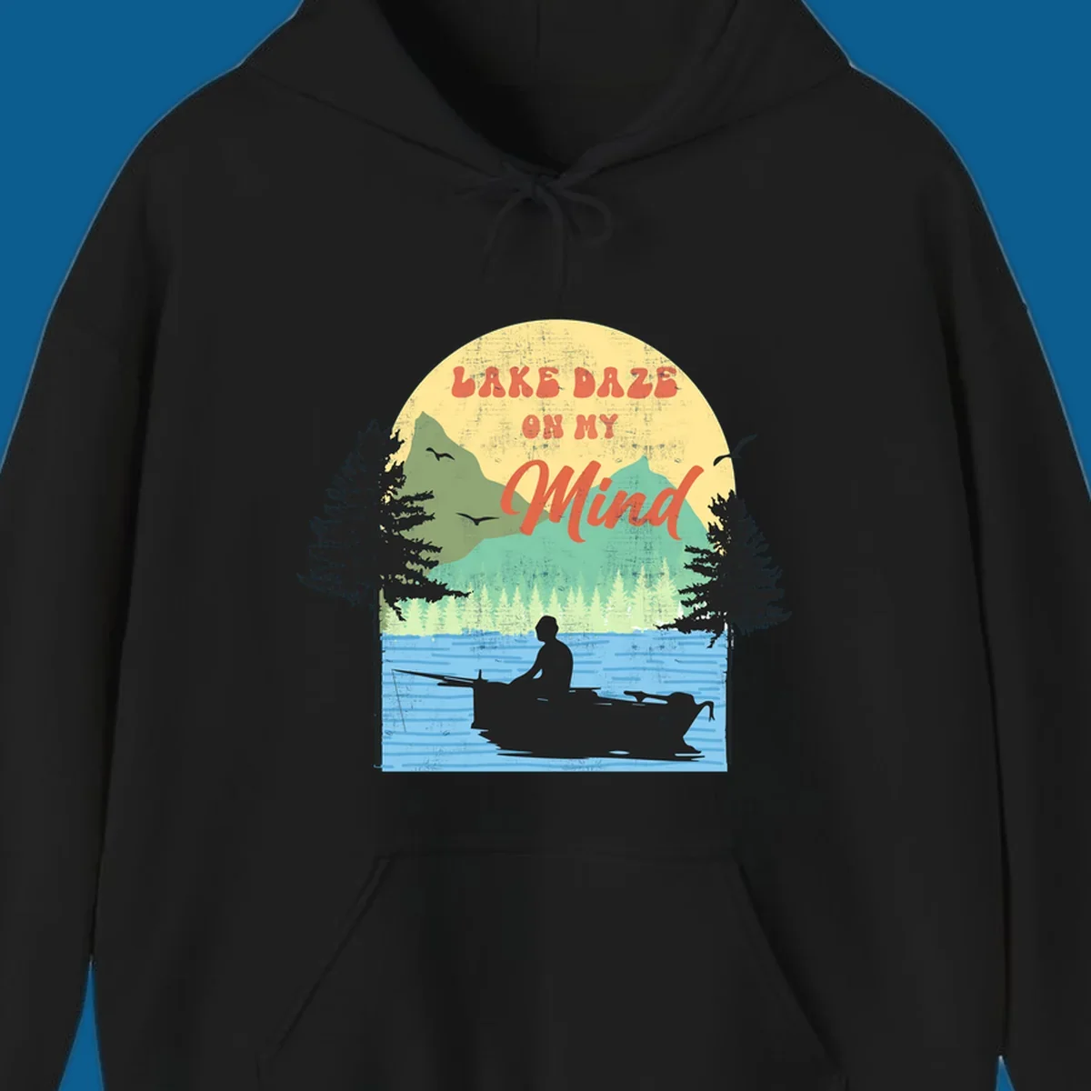 Lake daze fishing design featuring a person in a boat on a lake with trees and mountains.