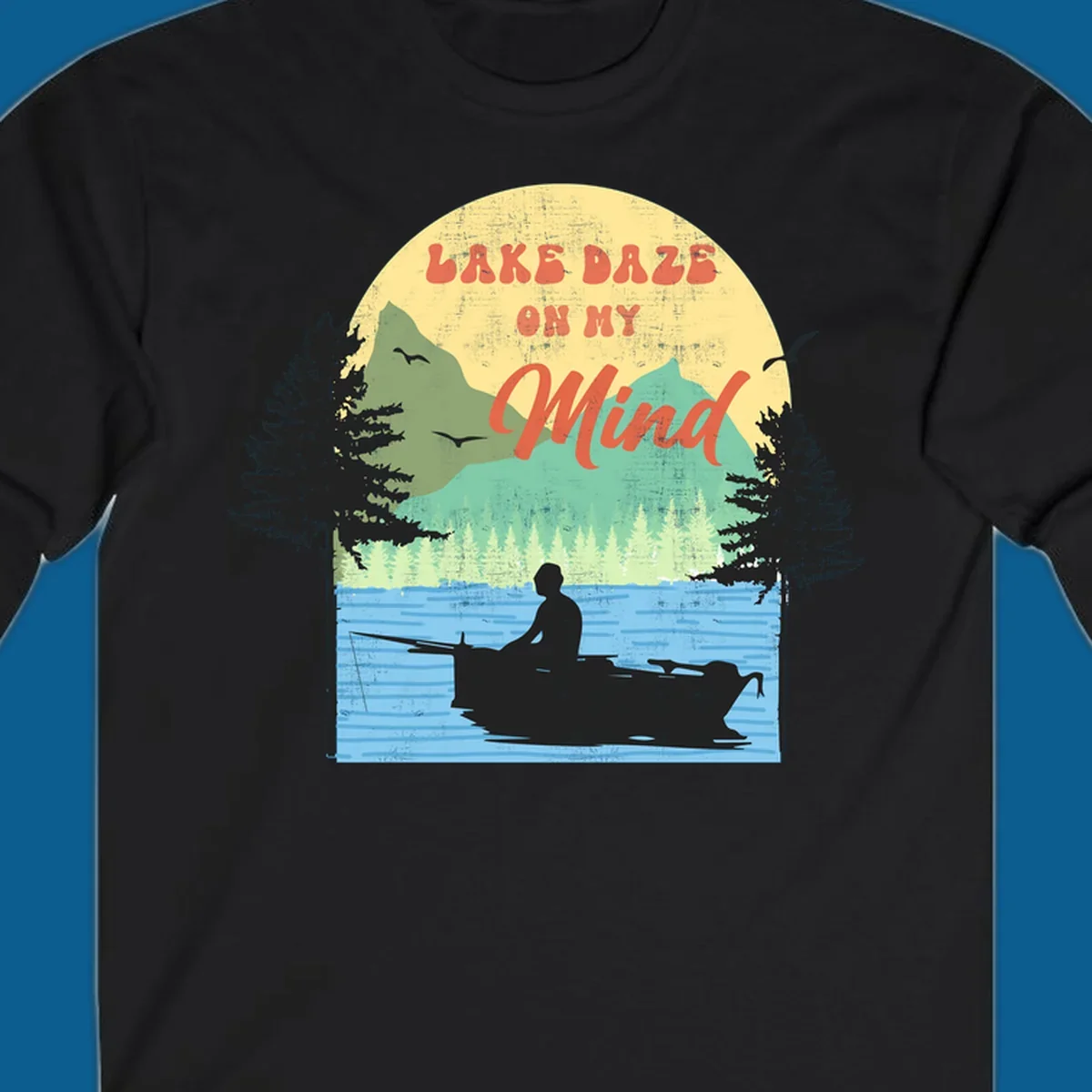 Lake daze fishing design featuring a person in a boat on a lake with trees and mountains.