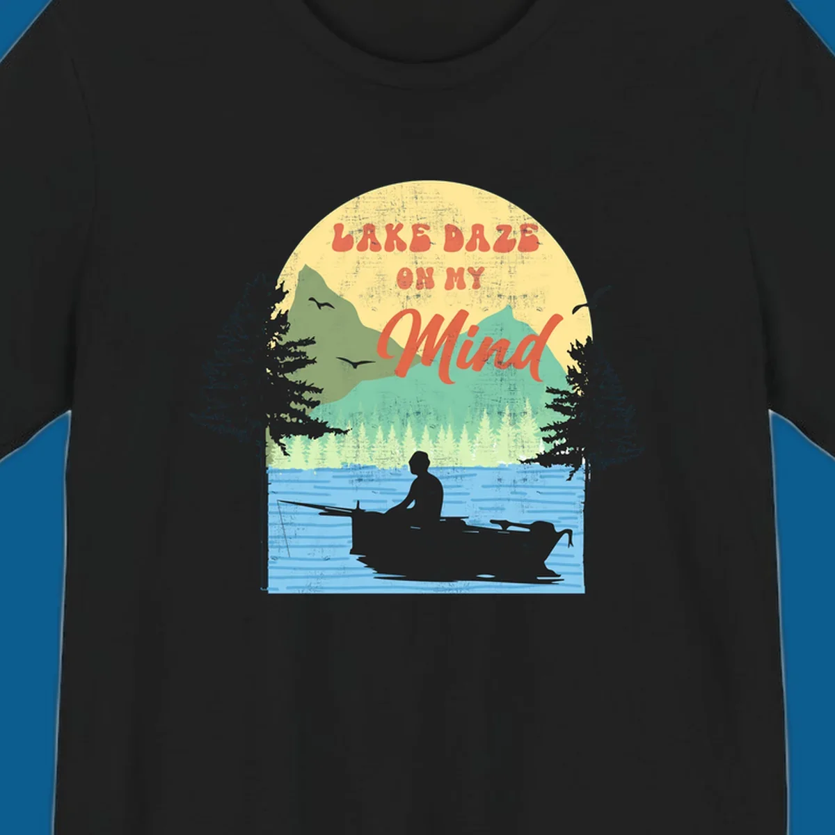 Lake daze fishing design featuring a person in a boat on a lake with trees and mountains.