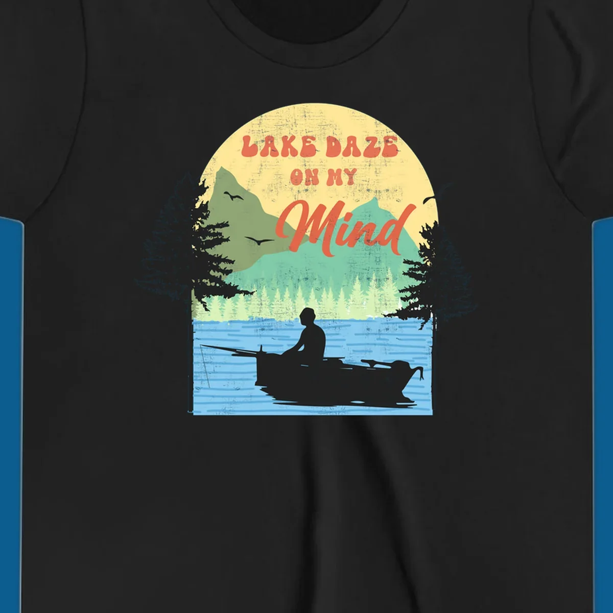 Lake daze fishing design featuring a person in a boat on a lake with trees and mountains.