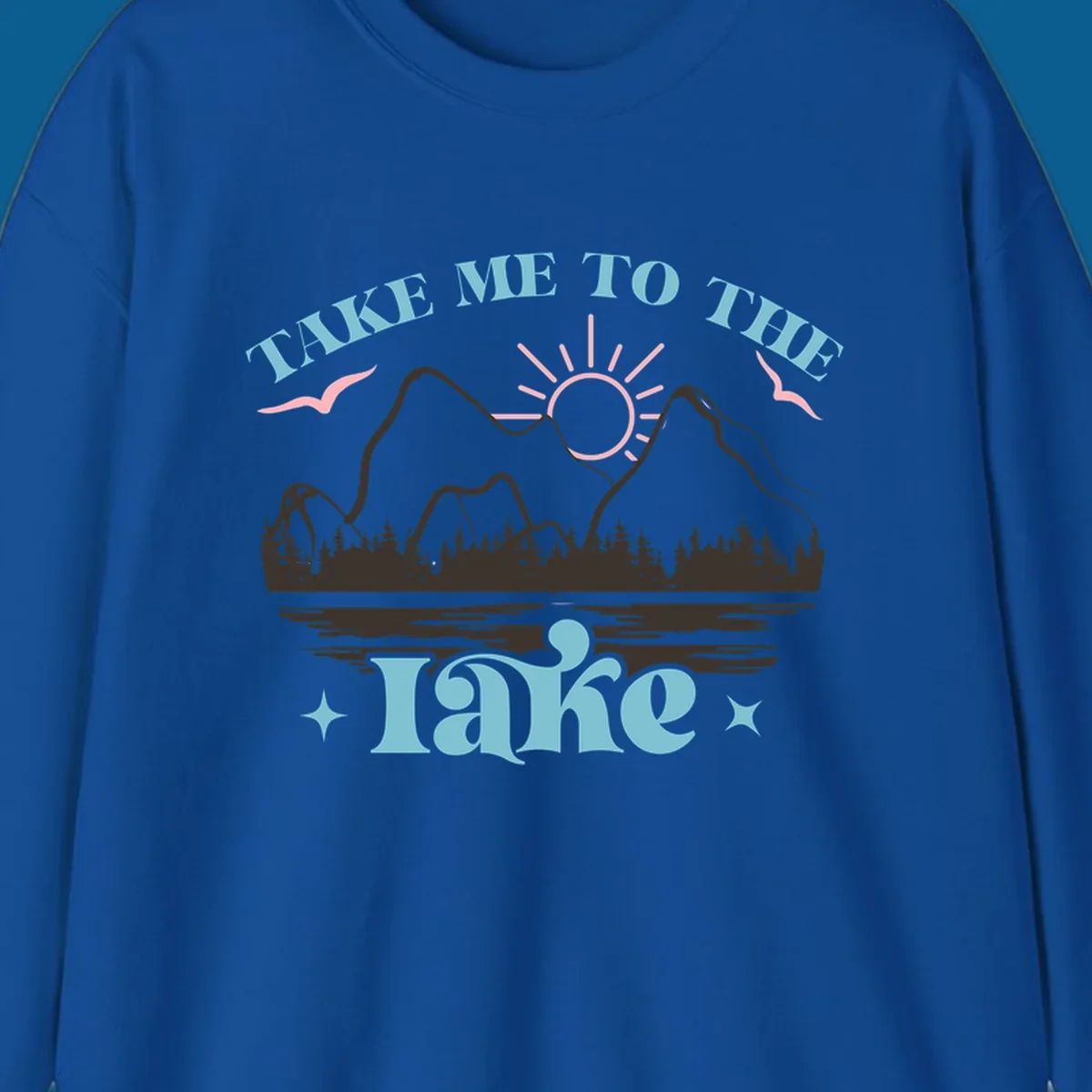 Illustration of mountains, lake, sun, and birds with text 'Take Me To The Lake'.