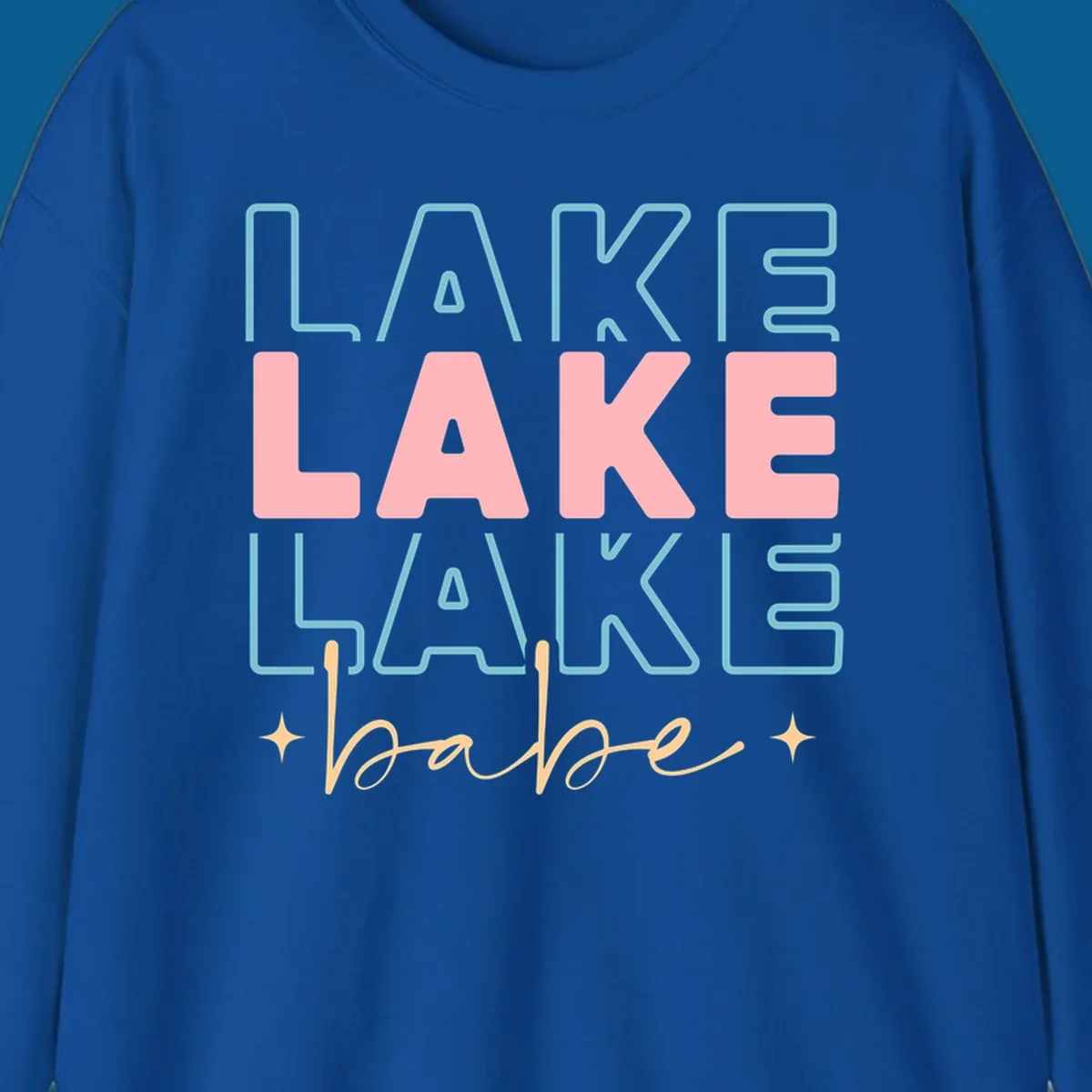 Retro typography design featuring the words LAKE LAKE LAKE and babe, with gold starburst accents.