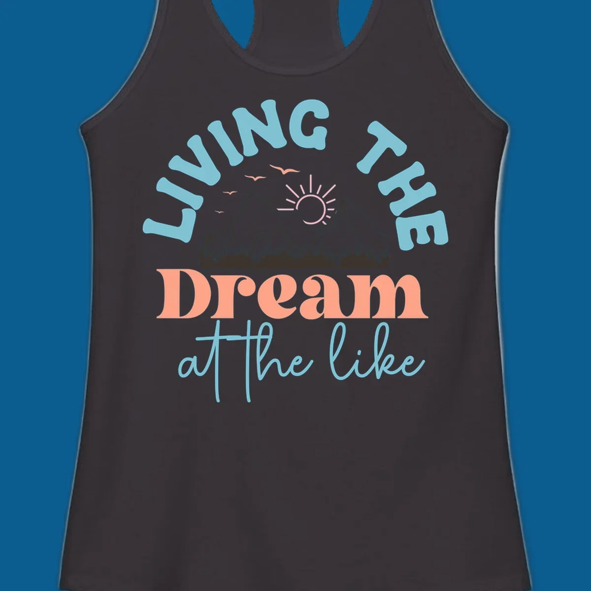 Illustration of mountains with a sunrise and birds above the text 'Living The Dream At The Like'.