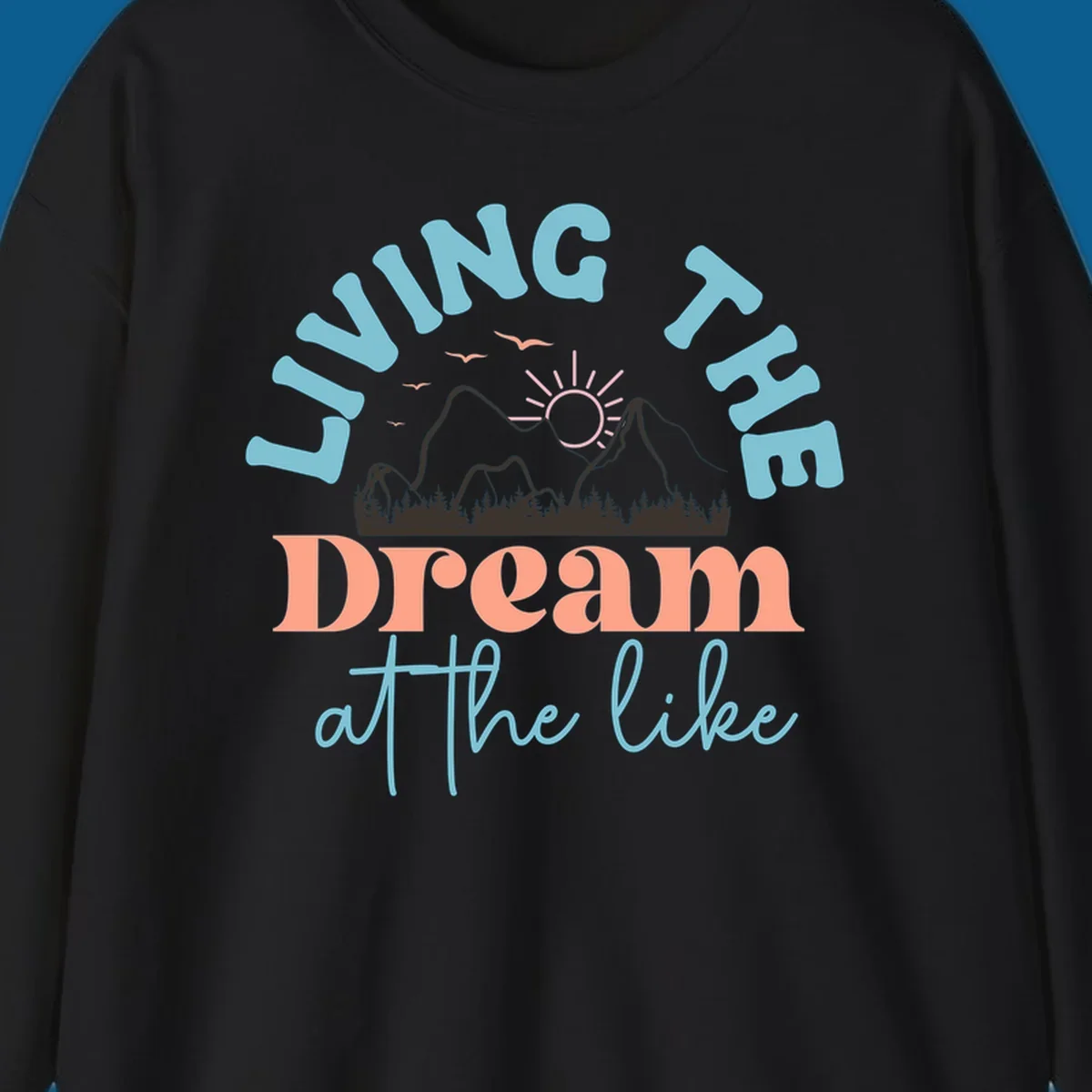 Illustration of mountains with a sunrise and birds above the text 'Living The Dream At The Like'.