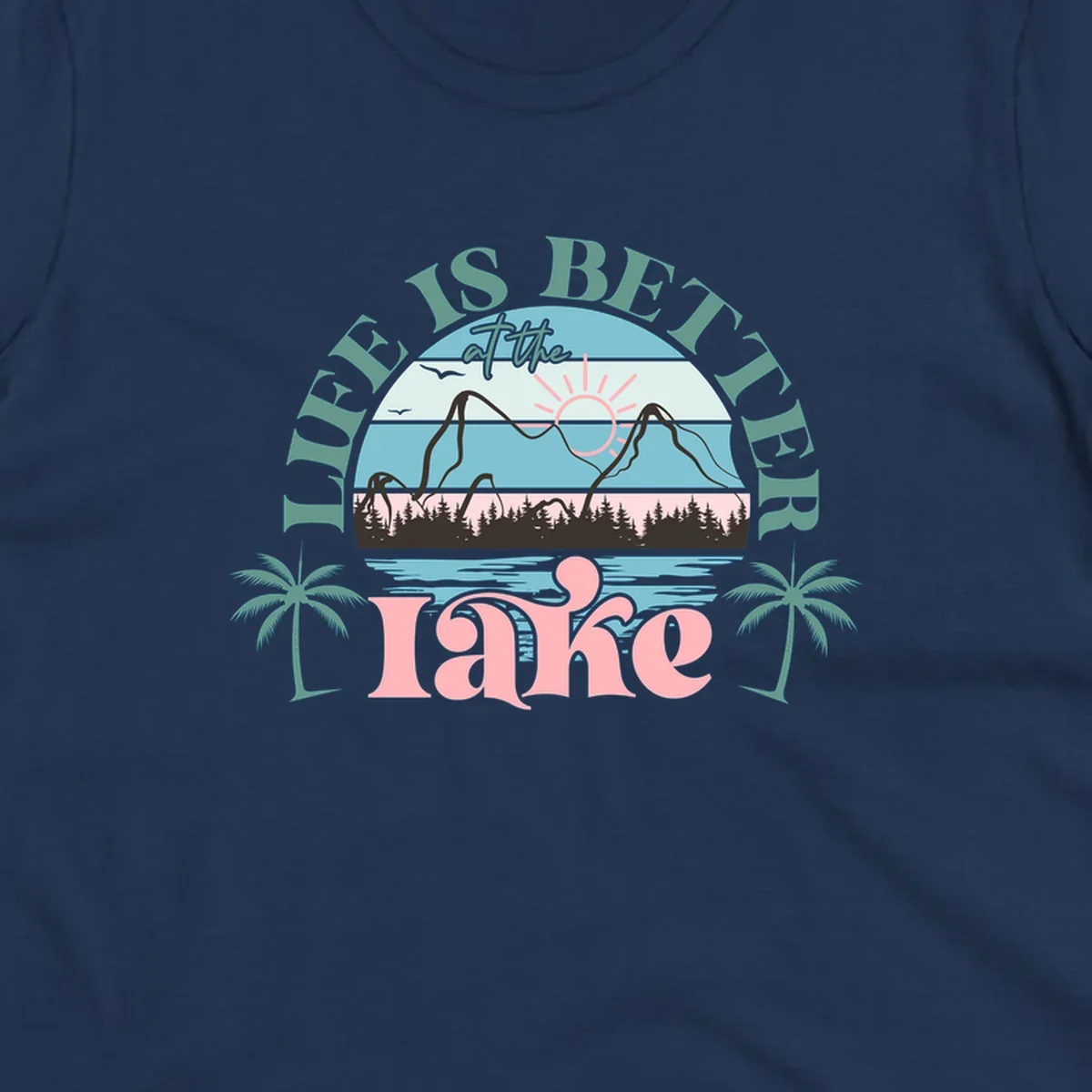 Life is better at the lake scenic design with mountains, trees, lake, and palm trees.
