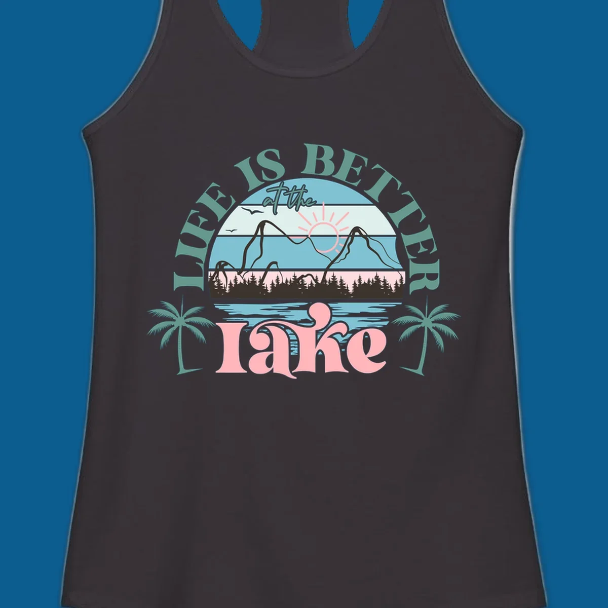 Life is better at the lake scenic design with mountains, trees, lake, and palm trees.