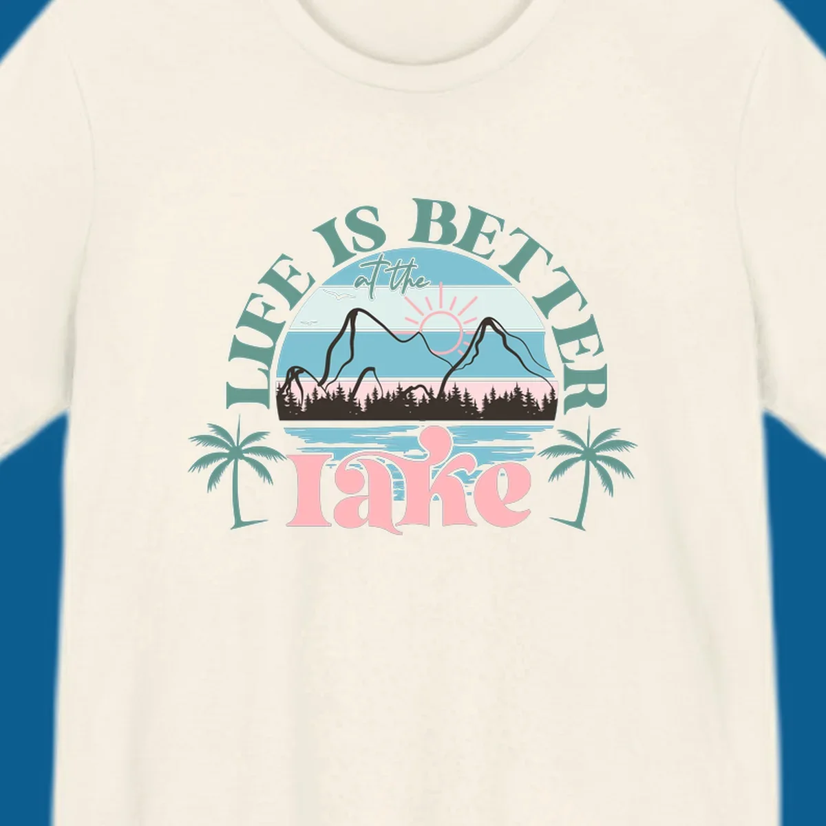 Life is better at the lake scenic design with mountains, trees, lake, and palm trees.