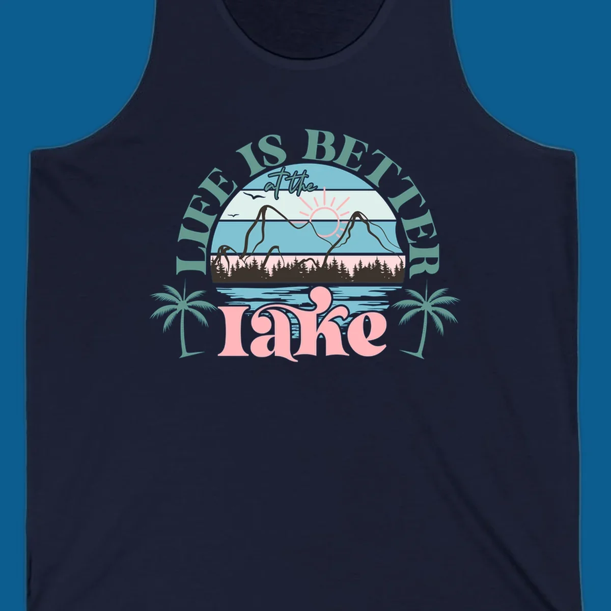Life is better at the lake scenic design with mountains, trees, lake, and palm trees.