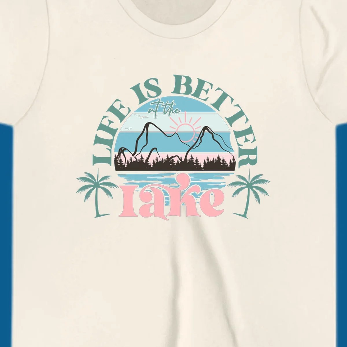Life is better at the lake scenic design with mountains, trees, lake, and palm trees.