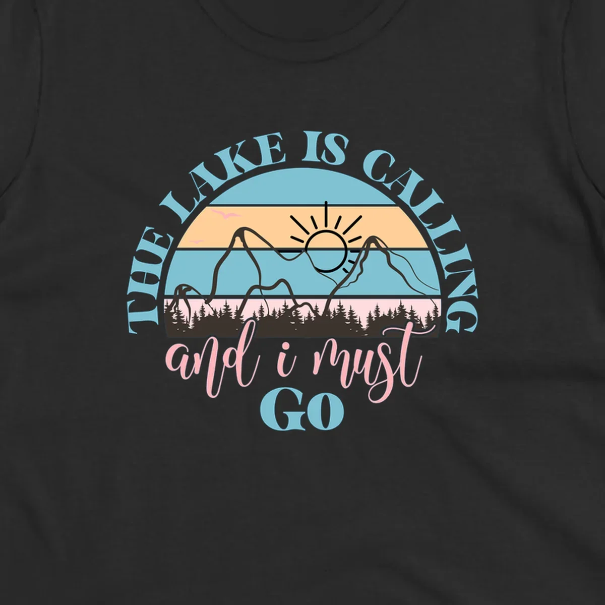 The Lake Is Calling And I Must Go text with mountain and sunset illustration.