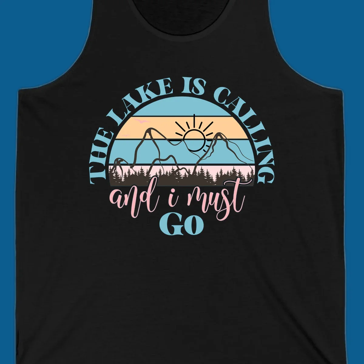 The Lake Is Calling And I Must Go text with mountain and sunset illustration.