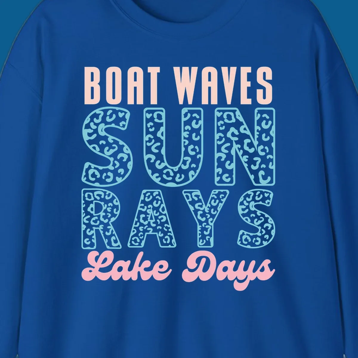Boat waves sun rays lake days text design with pink and teal leopard print.