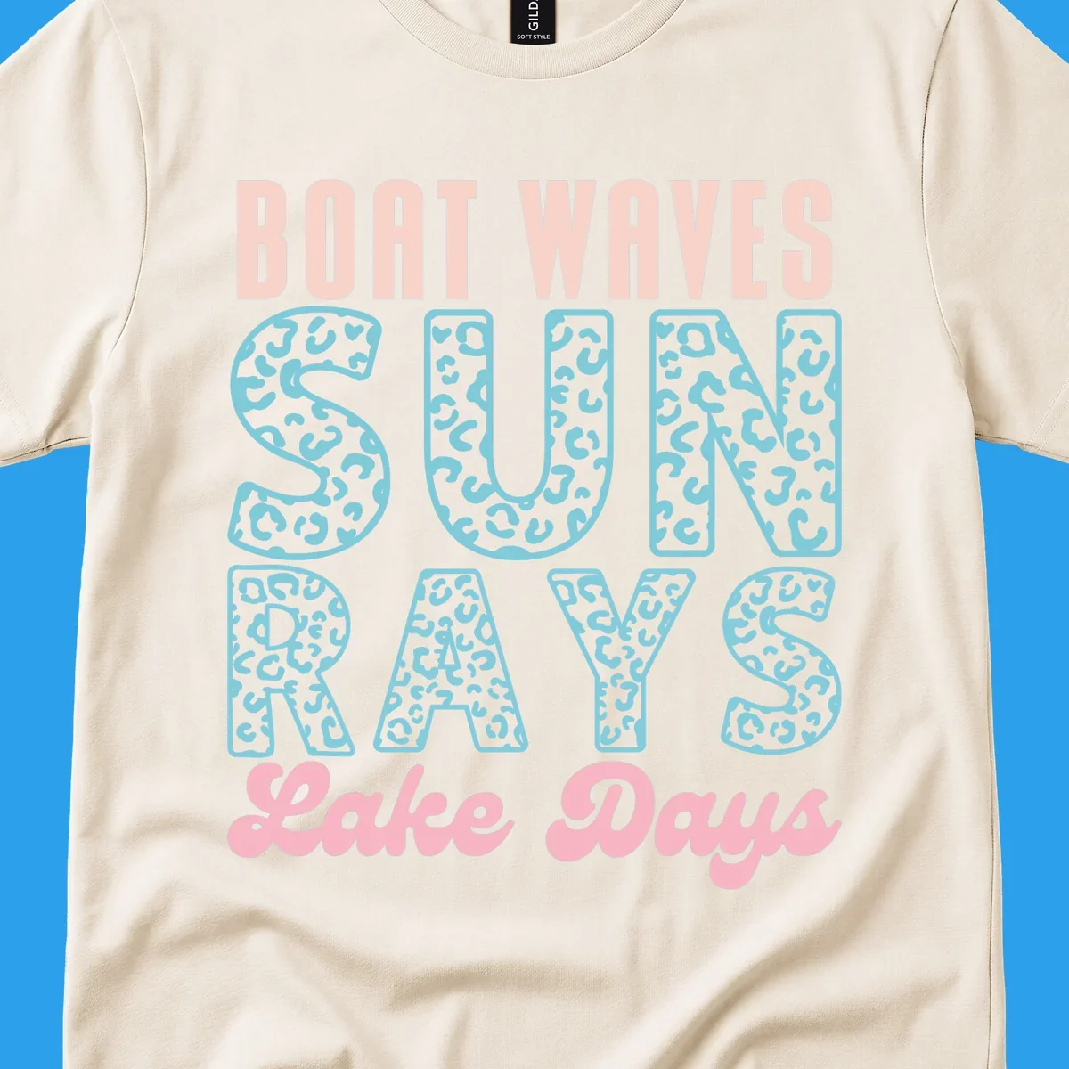 Boat waves sun rays lake days text design with pink and teal leopard print.
