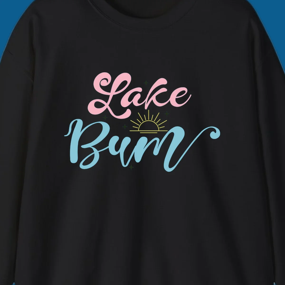 Lake Bum text design with a sunset graphic, in pink and blue script.