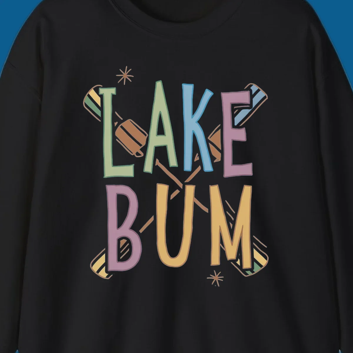 Lake Bum text with crossed oars and starbursts in colorful hand-drawn lettering.