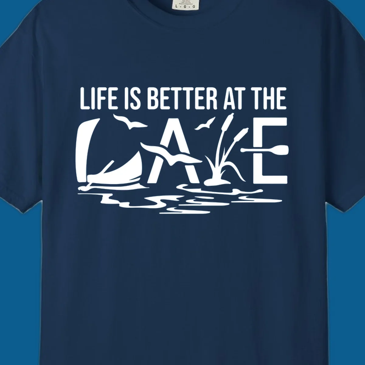 Life Is Better At The Lake design with sailboat, birds, reeds, paddle, and text.