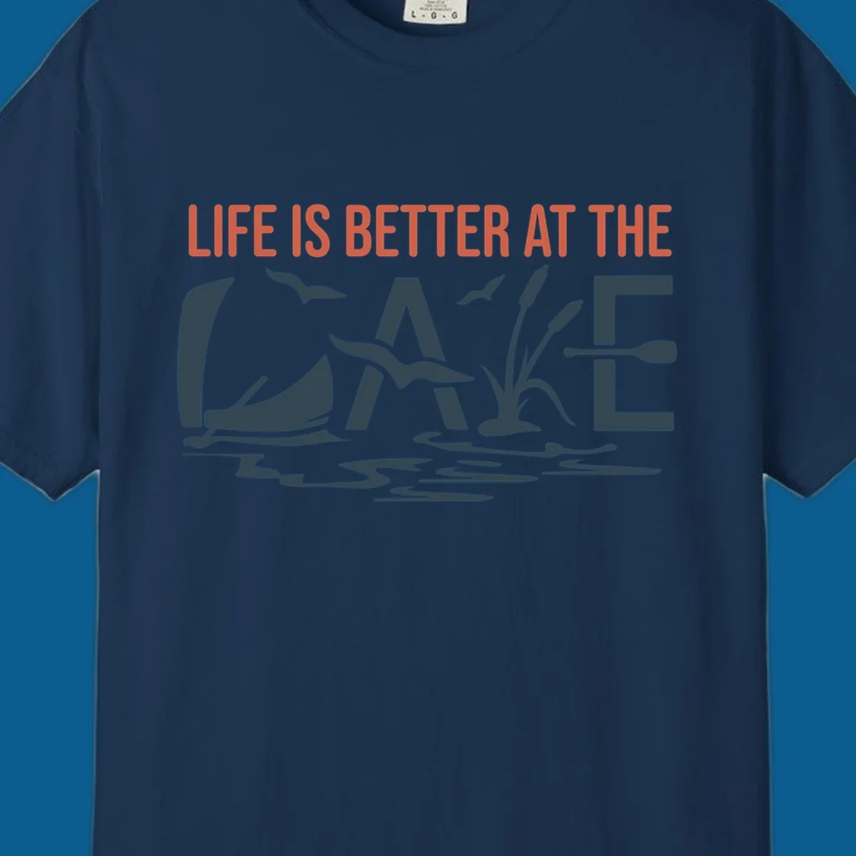 Graphic text design 'LIFE IS BETTER AT THE LAKE' with sailboat, birds, cattails, and paddle elements.