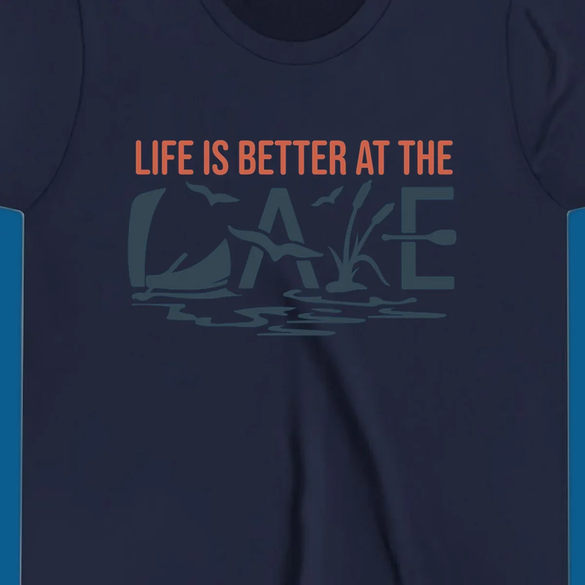 Graphic text design 'LIFE IS BETTER AT THE LAKE' with sailboat, birds, cattails, and paddle elements.