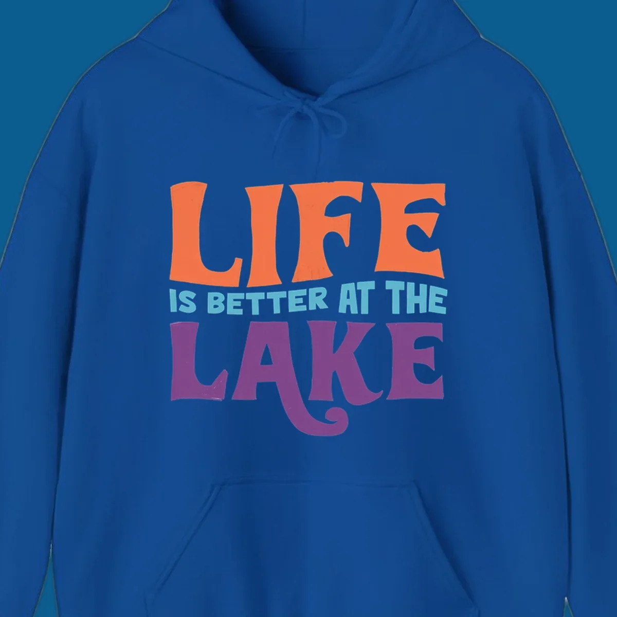 Retro typography design stating "LIFE IS BETTER AT THE LAKE" in orange, teal, and purple.