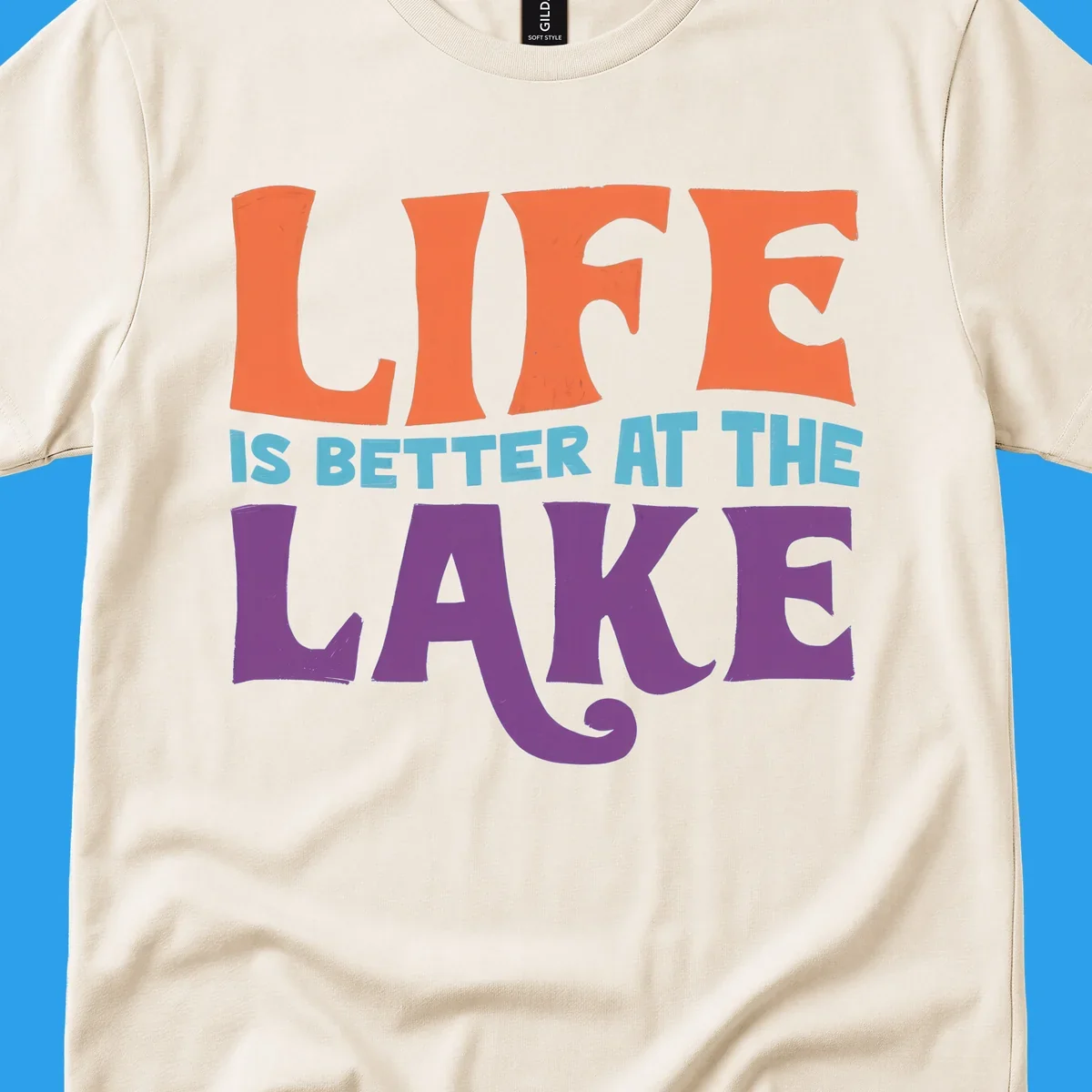 Retro typography design stating "LIFE IS BETTER AT THE LAKE" in orange, teal, and purple.